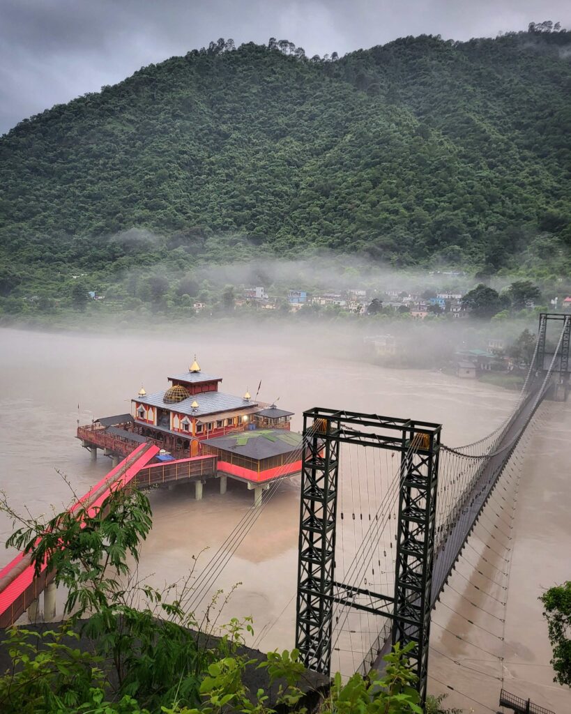 Dhari Devi Temple above the Alaknanda River during monsoon in Uttarakhand.